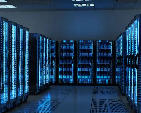 Data center with rows of illuminated server racks, representing the use of MySQL, MongoDB, and PostgreSQL for efficient database management and integration in DevOps consulting services.