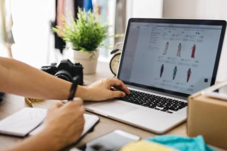 Person working on a laptop displaying an online fashion store, highlighting Samyak Infotech's development of a scalable and user-friendly e-commerce platform with AngularJS for a leading fashion retailer, resulting in increased online sales and customer satisfaction.