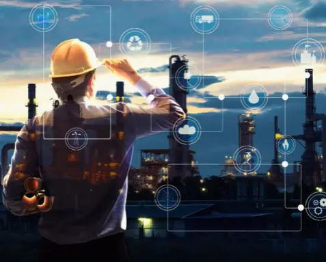 An engineer wearing a hard hat looks at a refinery plant with digital icons overlaying the scene, illustrating the use of Power Automate services to automate scheduling and monitoring maintenance in the energy sector for improved safety and cost efficiency.