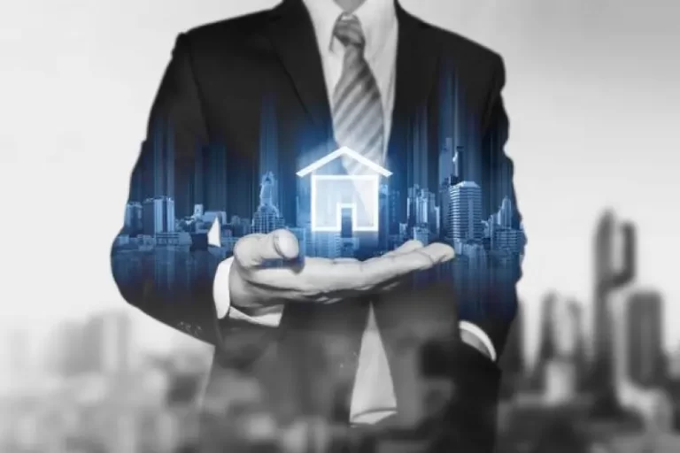 A businessman holding a glowing house icon with a cityscape in the background, representing the use of Power Automate services to improve sales processes, increase lead conversion rates, and enhance client follow-up in the real estate industry.