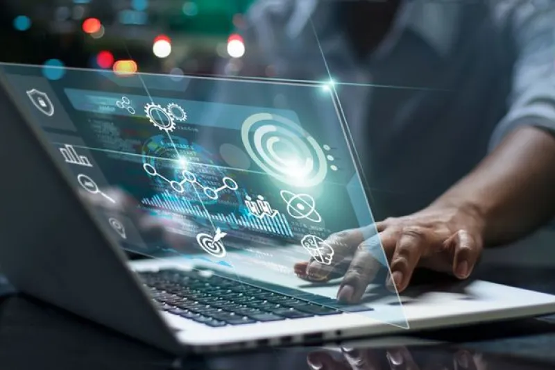 A person working on a laptop with a digital interface showing data analytics and automotive symbols, representing the use of machine learning development services for predictive maintenance and advanced driver assistance systems to improve vehicle safety and customer satisfaction.