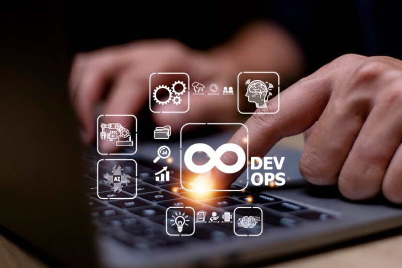 A hand pressing a key on a keyboard with digital icons overlay, including the DevOps infinity loop, representing the integration of monitoring and logging tools in DevOps consulting services to improve system reliability and reduce downtime.